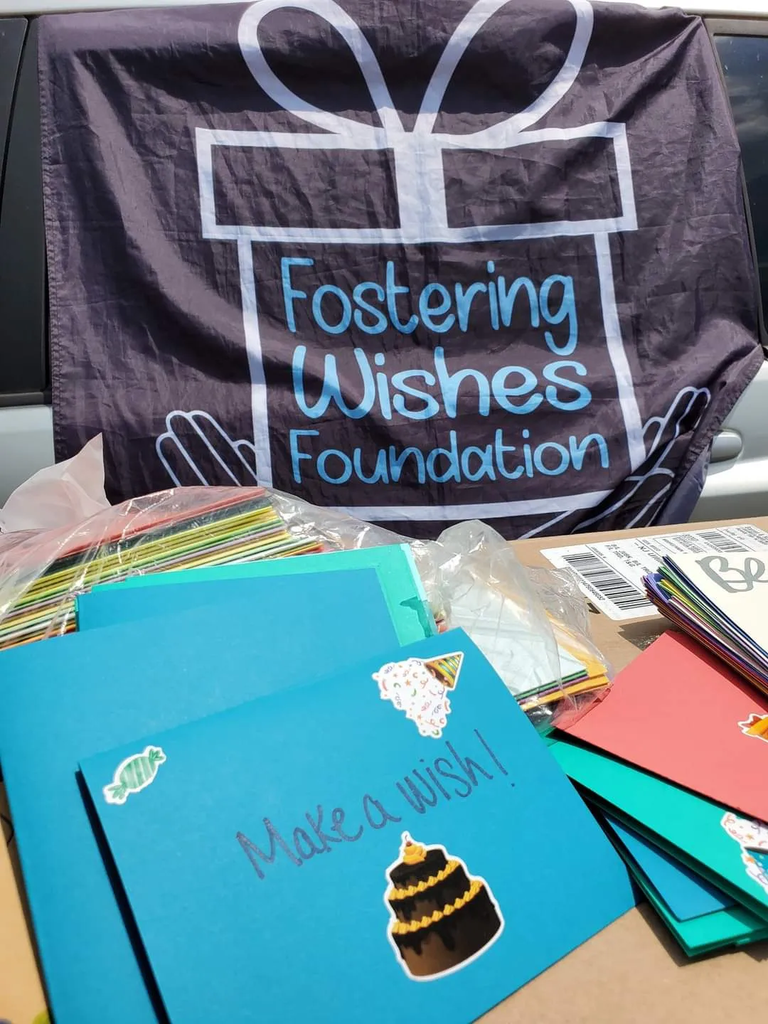 The Fostering Wishes flag, flown with a Girl Scouts wish card