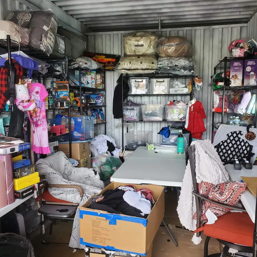 Shelves inside the Little Free Store stocked with clothing, bedding, toys and household basics